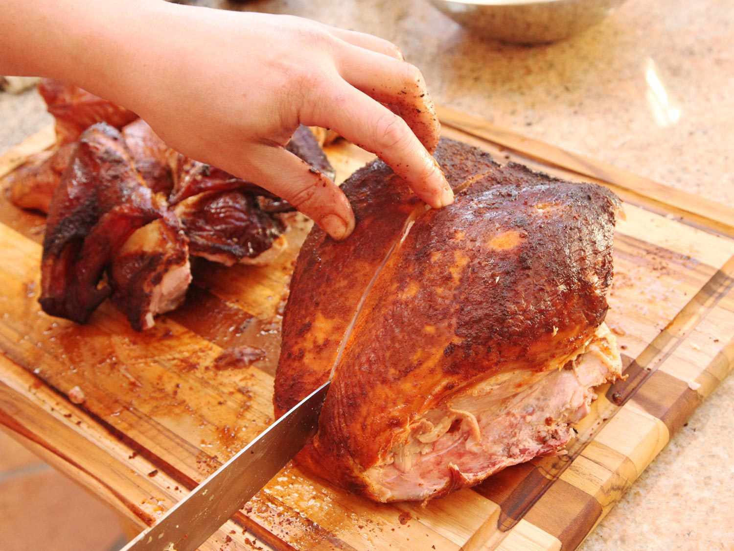 Carving smoked turkey breast.