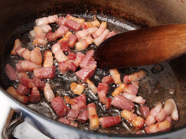 Browning diced salt pork in a sauté pan.