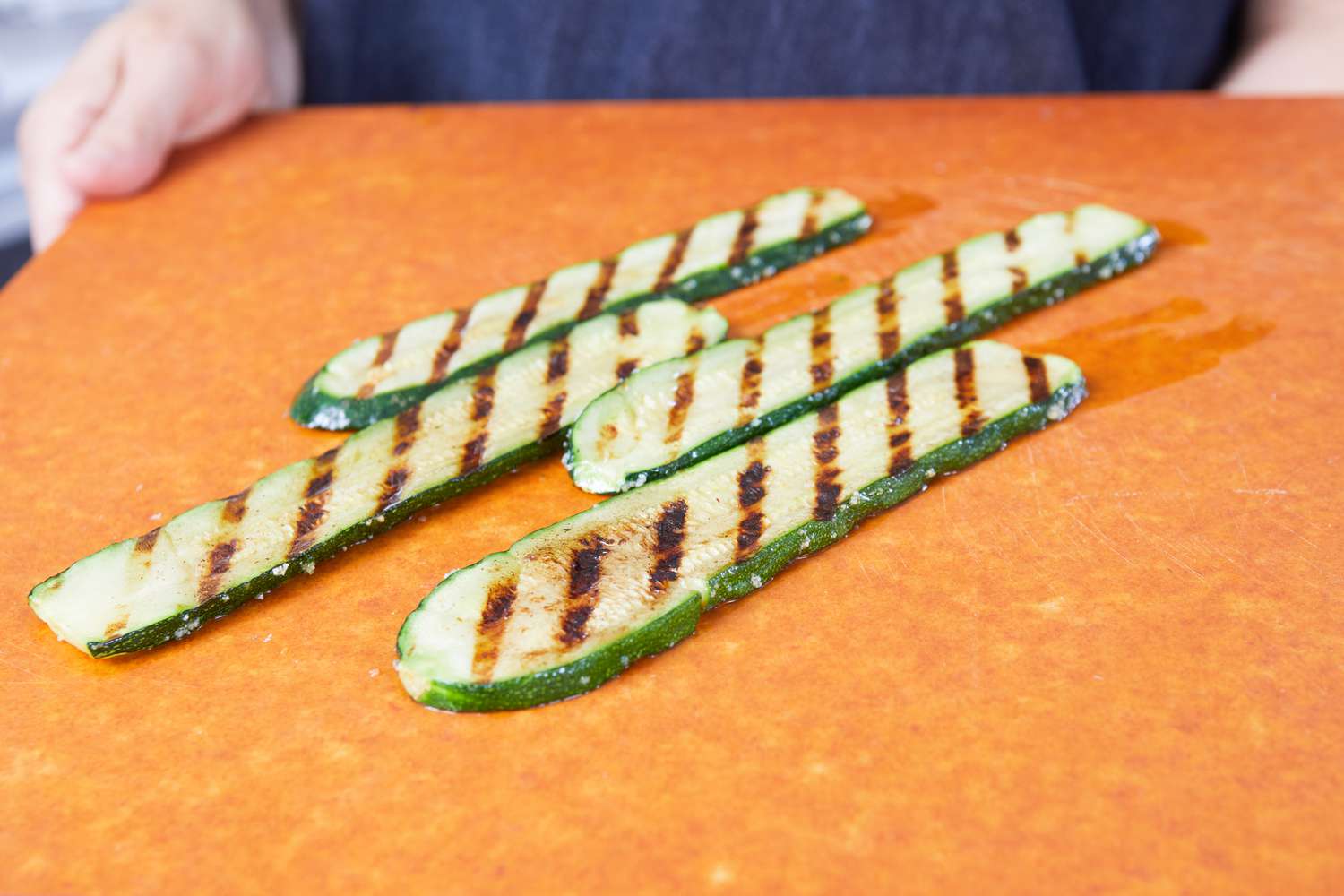 Zucchinis on a cutting board after being grilled using the Smithey Ironware Co. No. 12 Grill Pan.