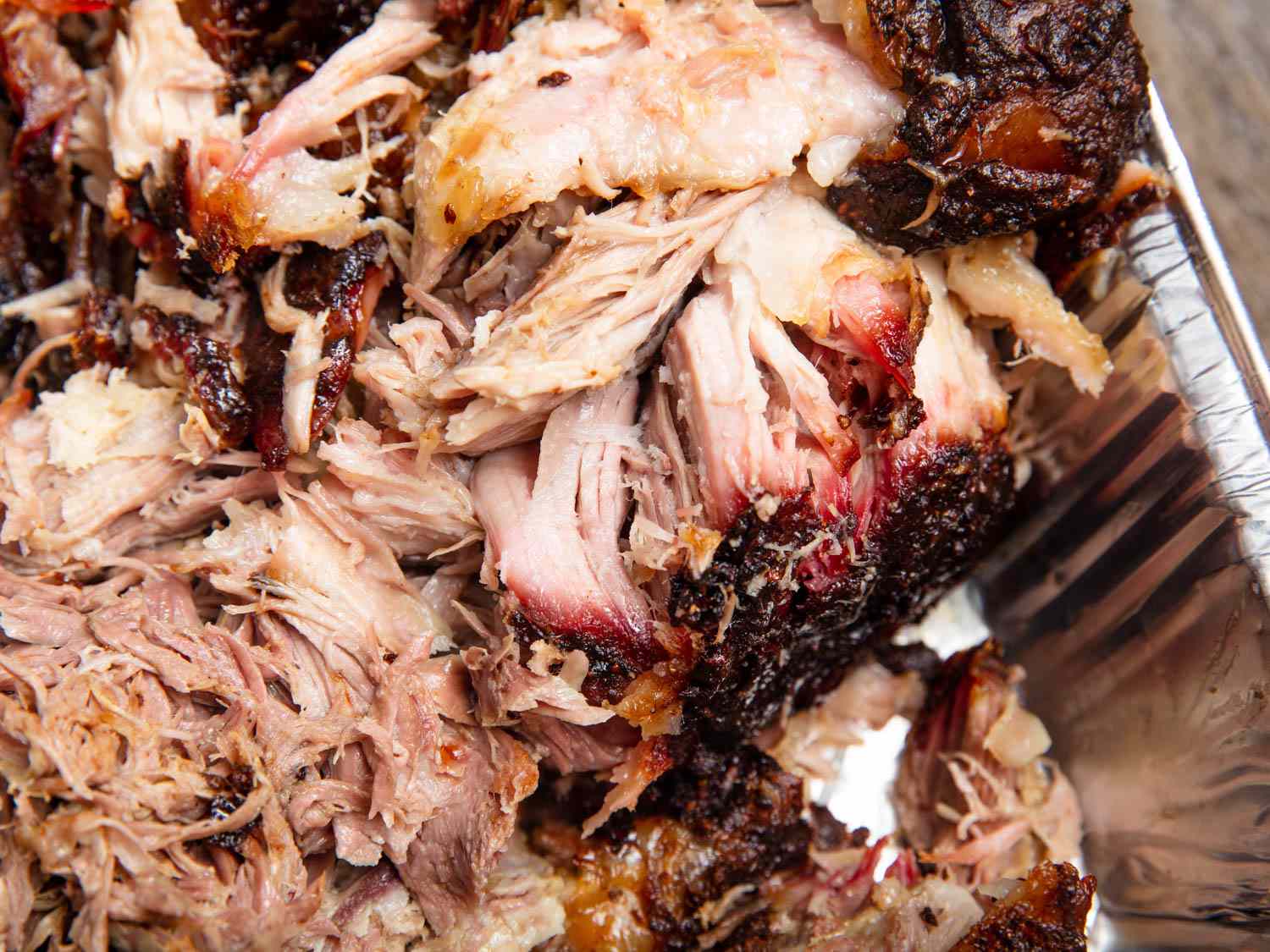 Close-up of the pulled pork, still relatively chunky and moistened with sauce.