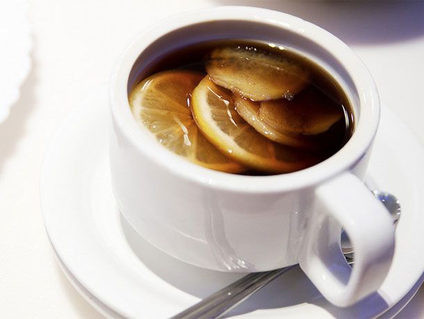 cup of boiled coke with lemon slices
