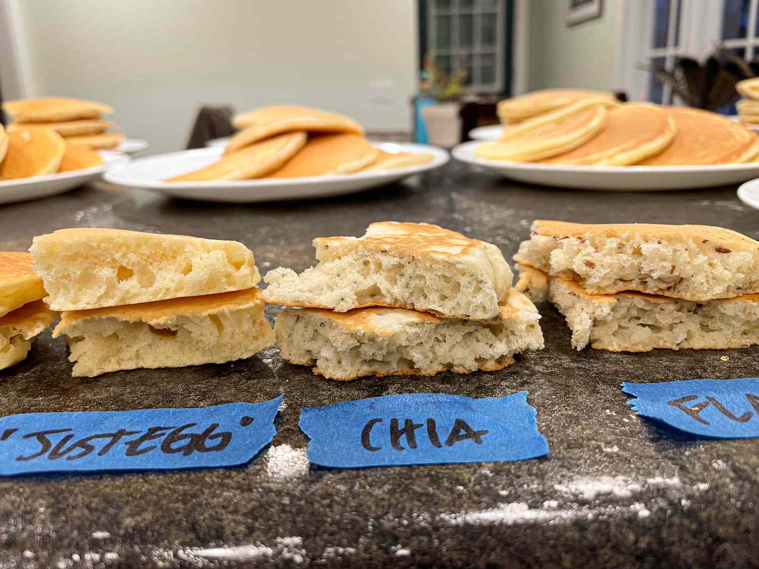 Three stacks of pancake pieces labeled with different egg substitutes including JustEgg Chia and Flax