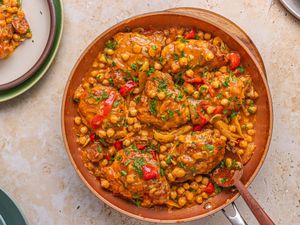 A skillet meal with chicken, chorizo, chickpeas, and vegetables
