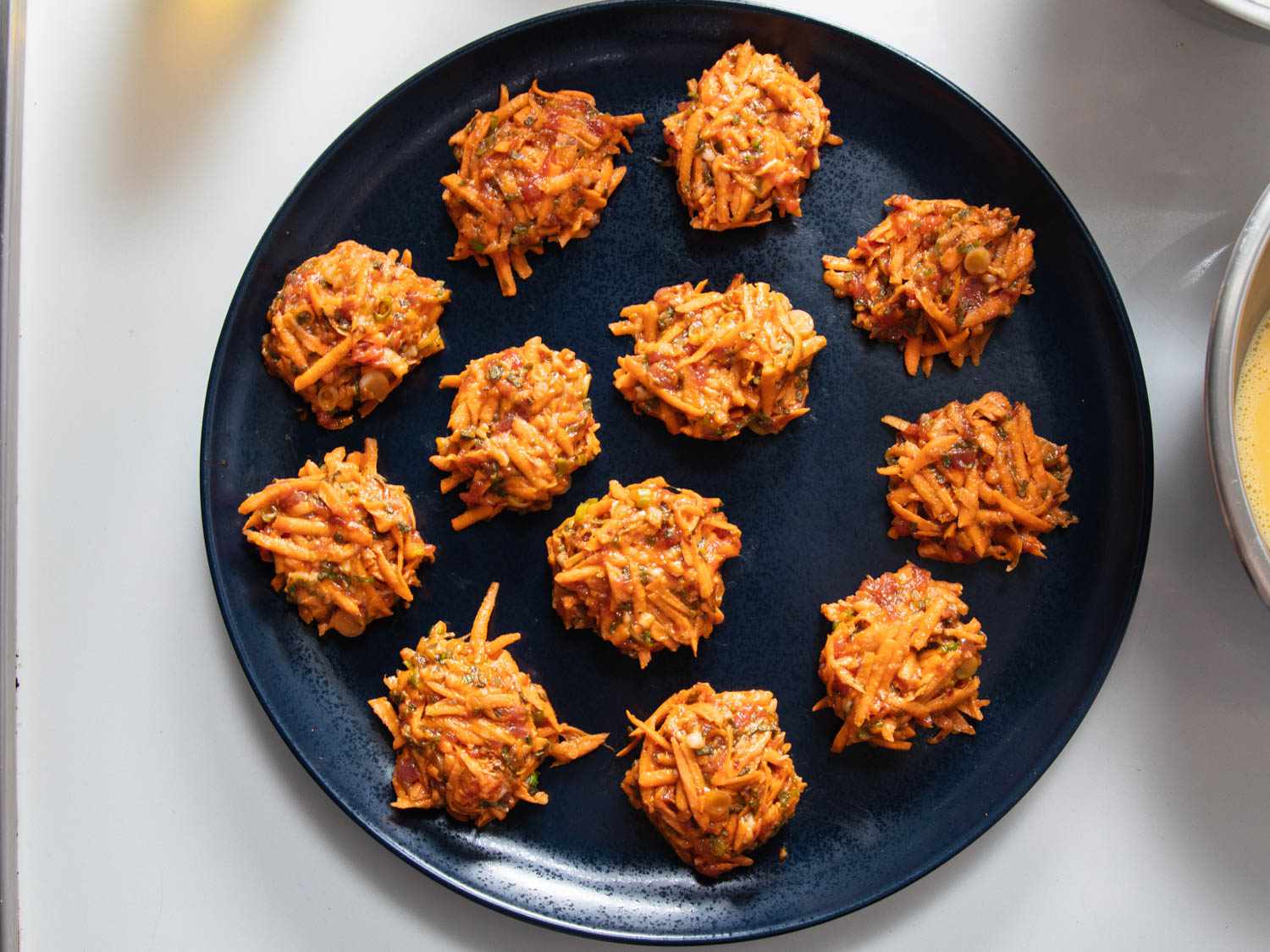 Mounds of sweet potato and sausage jeon mix ready for coating and frying 