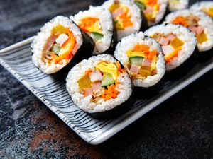 Rows of sliced Korean kimbap, which look similar to sushi and are filled with colorful sliced vegetables 