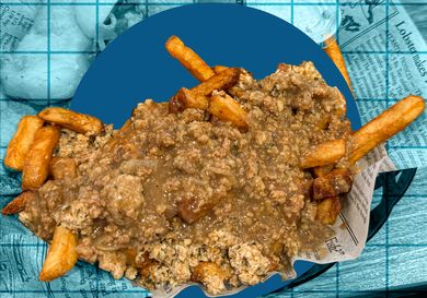 A plate of fries topped with minced meat and a sauce on a background resembling a blue grid and newspaper