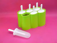 zoku popsicle molds on a pink background