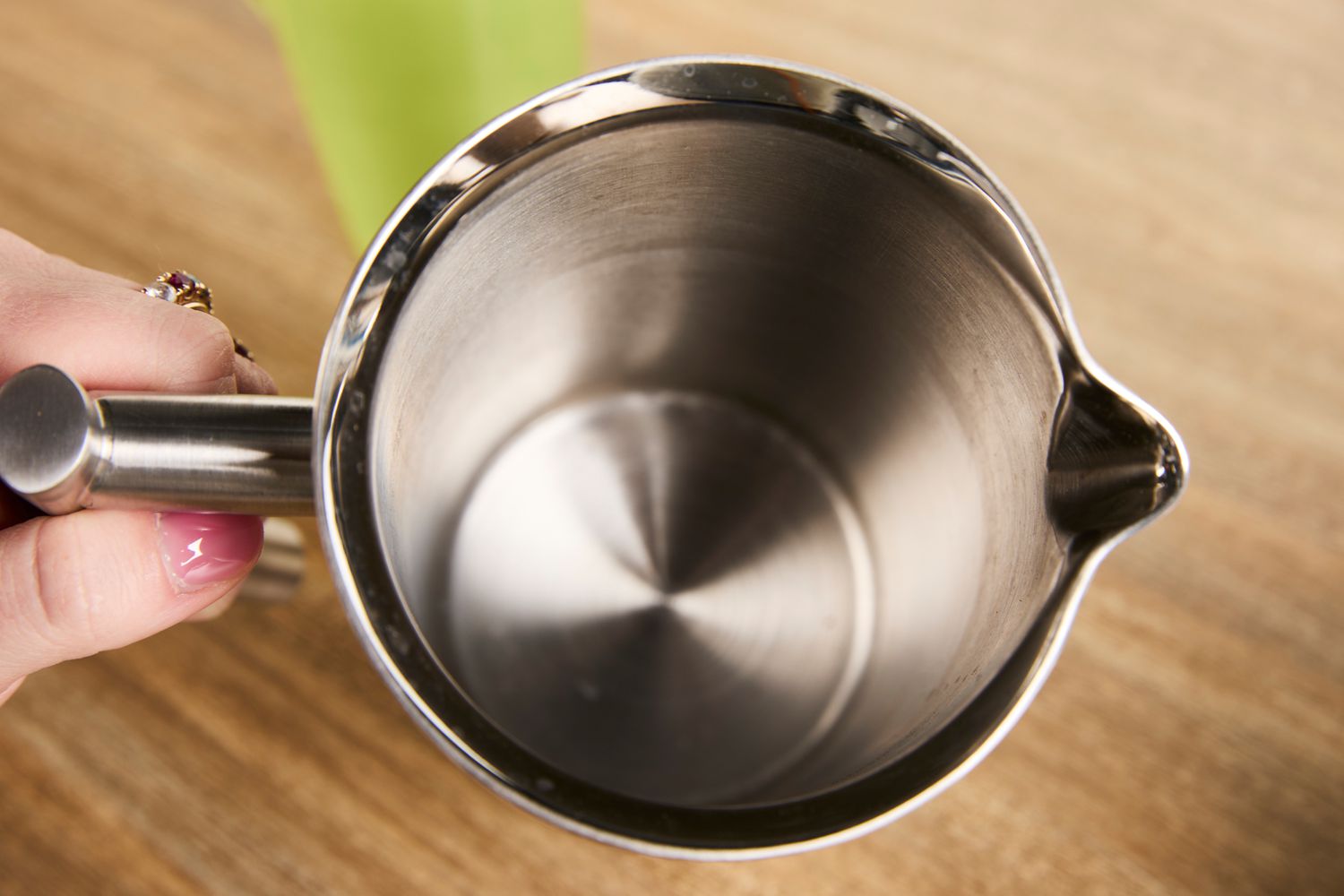 The interior of a stainless steel French press.
