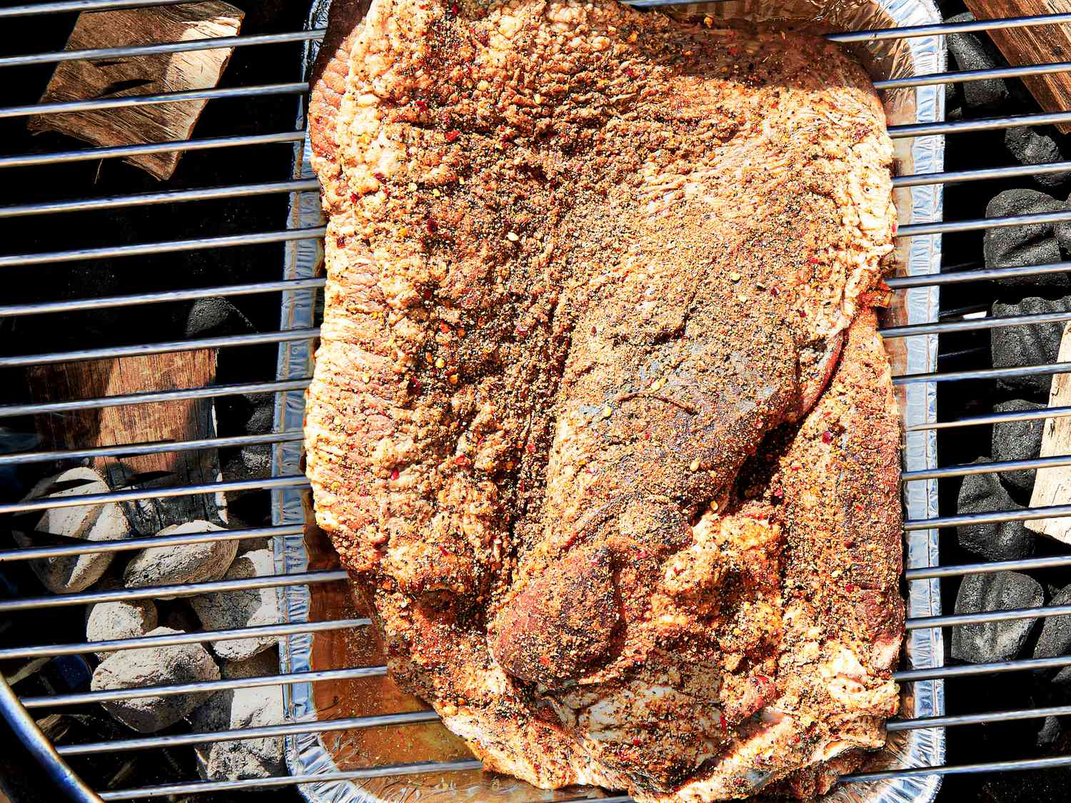 OVerhead view of brisket placed on grill grates