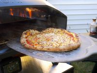 removing a pizza from the ooni koda 2 max