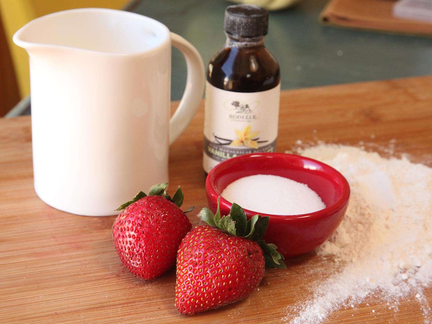 The simple five ingredients for strawberry shortcake: cream, strawberries, vanilla, sugar, and self-rising flour.