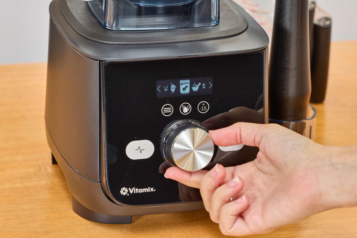 A hand turning a nob on the Vitamix Ascent X5 Blender