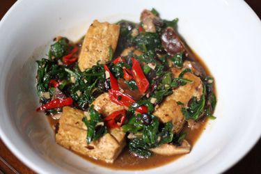A bowl of Home-Style Tofu with Mushrooms, Spinach, and Fermented Black Beans