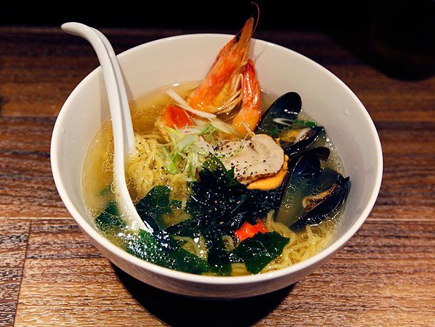Shrimp, scallops, and mussels in a bowl of ramen.