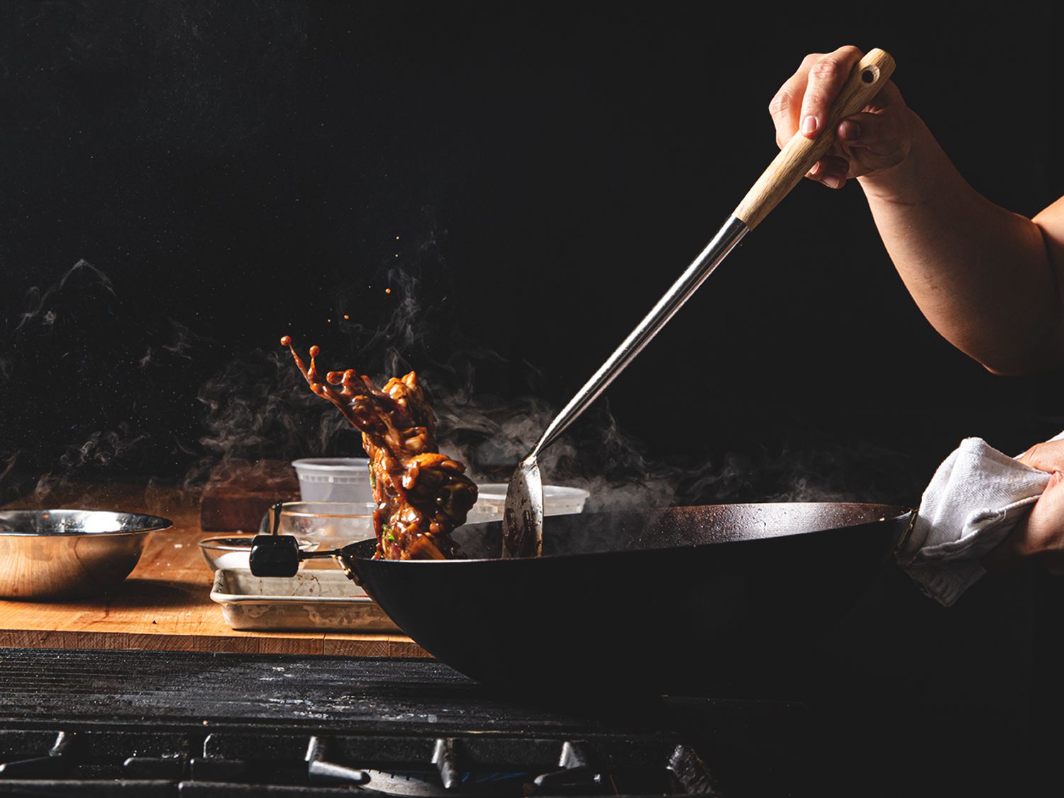 Braised chicken being tossed dramatically in a walk