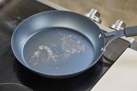 The bottom of the OXO Obsidian 10 Inch Pre-Seasoned Carbon Steel Frying Pan after use