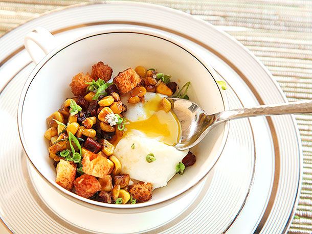 Sous vide poached eggs on top of bowl full of croutons