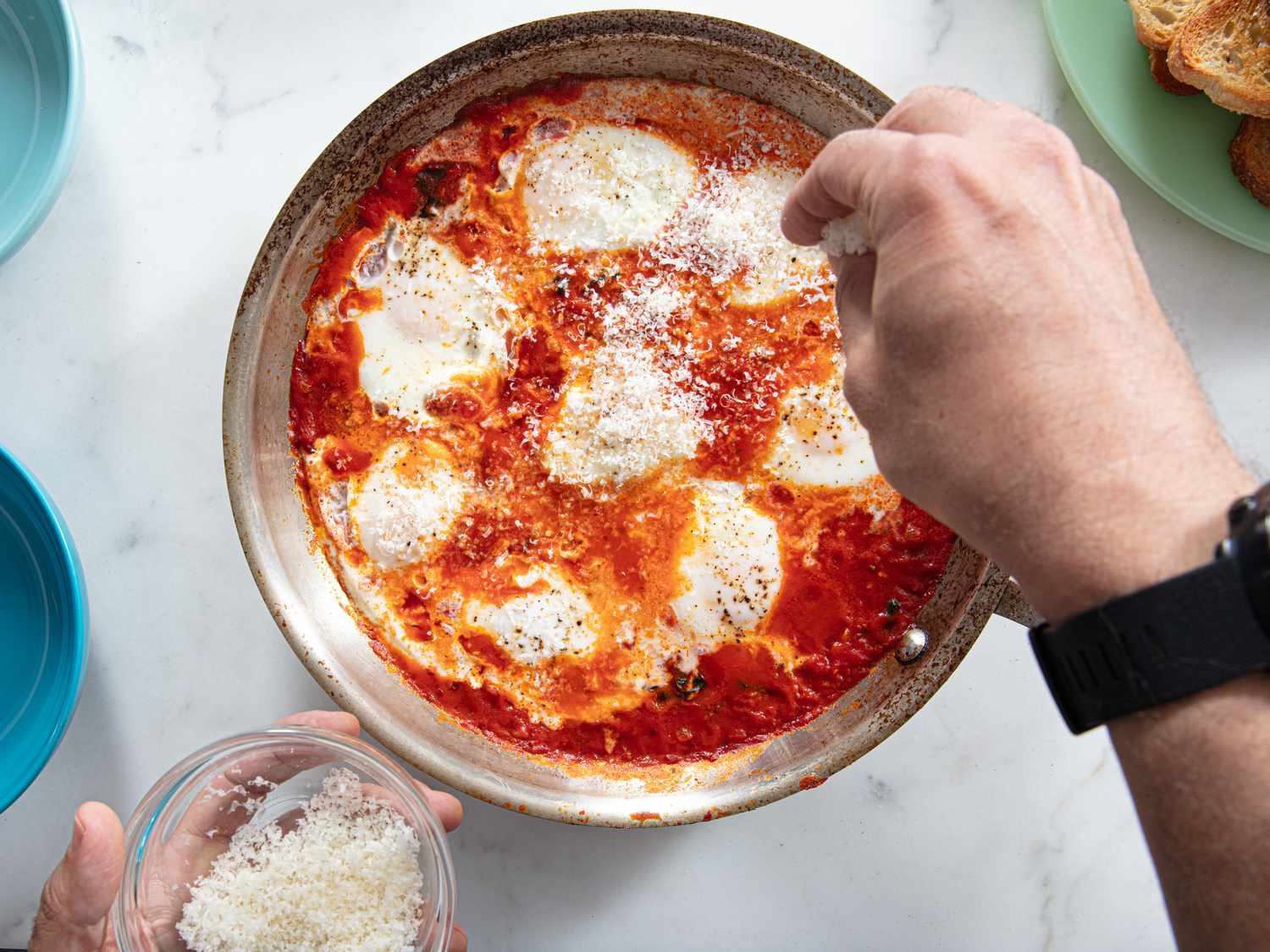 Topping eggs with parmesaen cheese