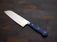wusthof santoku on a dark wood surface