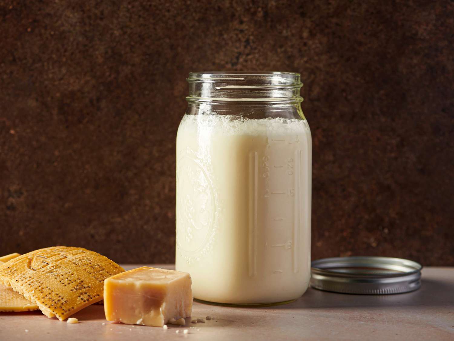Creamy Parmesan stock in an airtight glass container