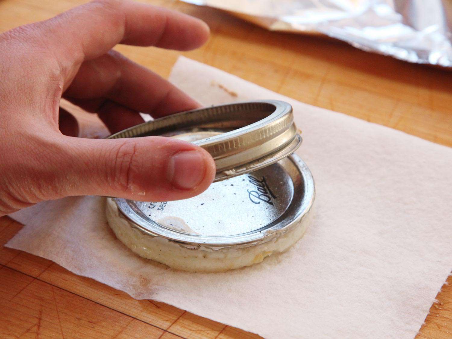 Removing the Mason jar lid ring from a cooked egg.