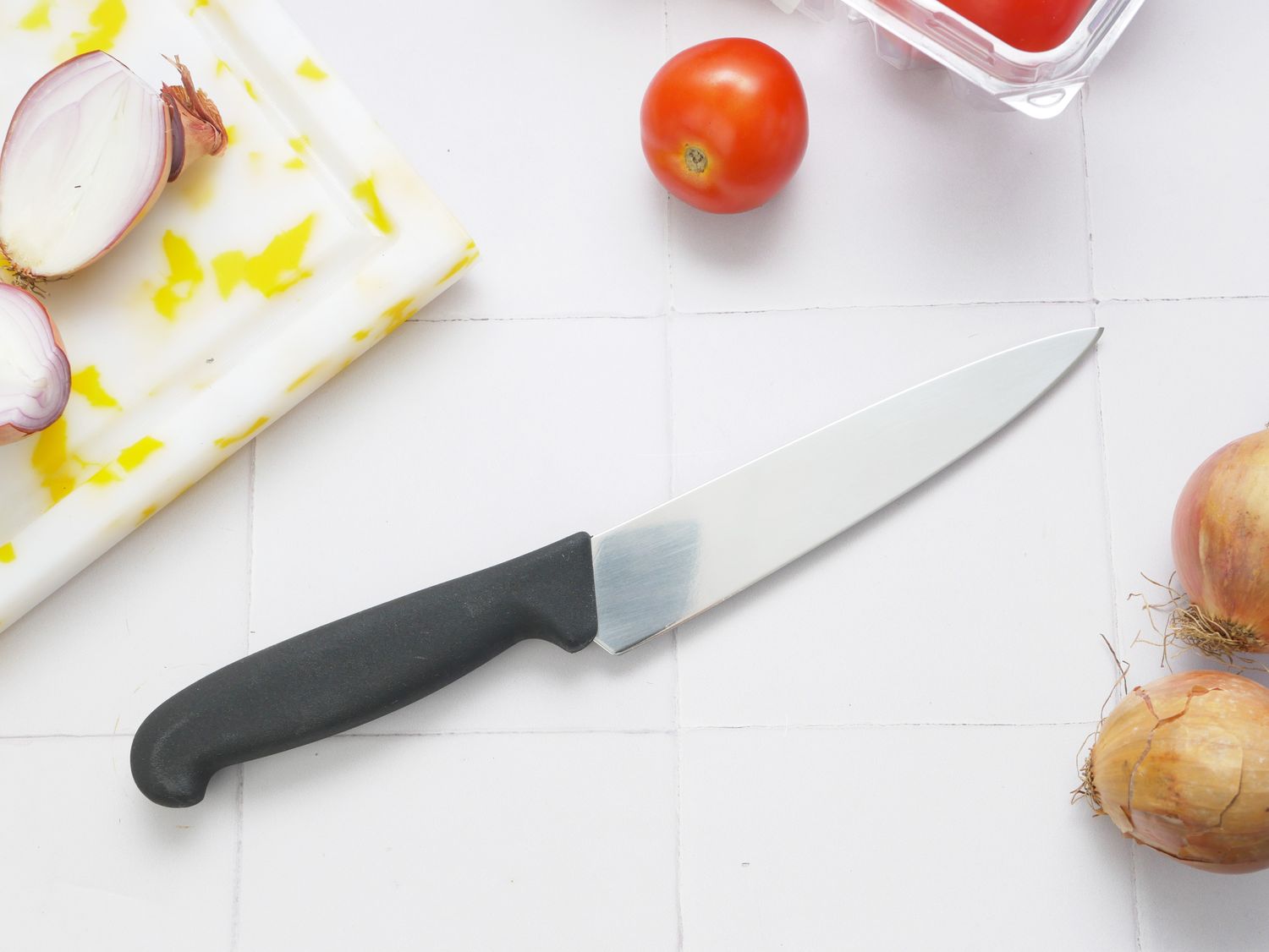 victorinox petty knife on a white tile surface