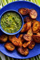 Overhead view of maduros on a blue plate with mint mojos on a striped green background