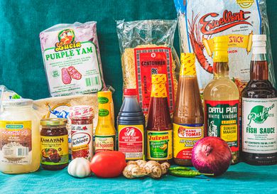 The essential elements of a Filipino pantry arranged in front of a blue backdrop