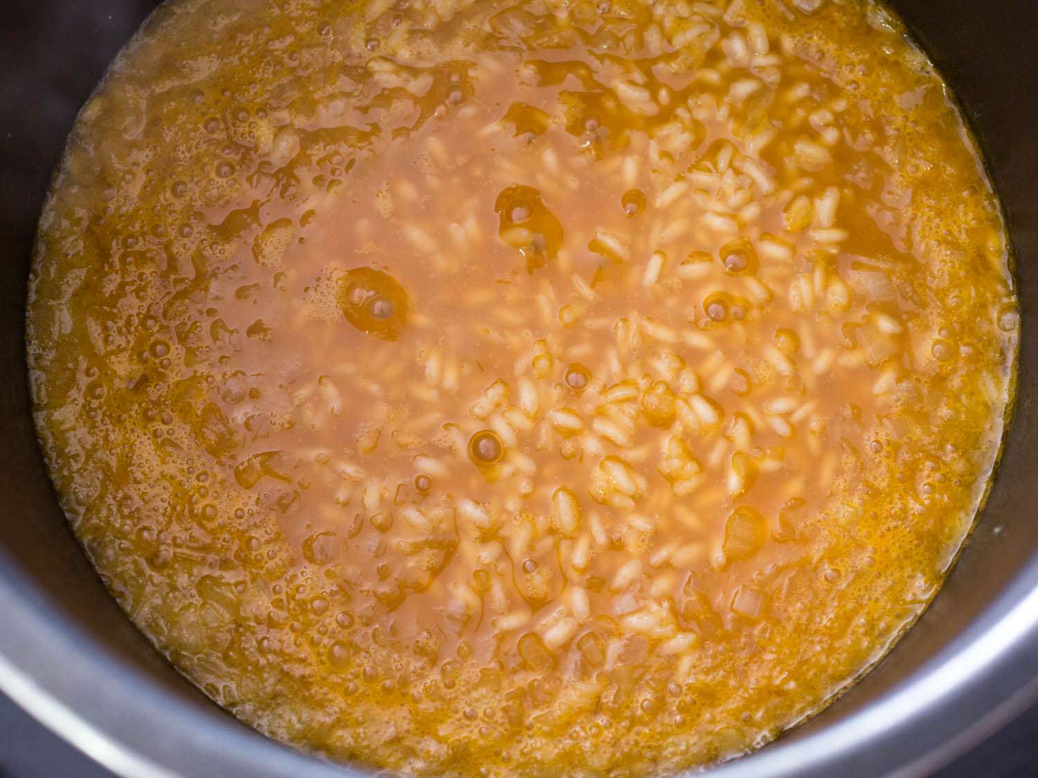 Butternut squash risotto looking soupy after the pressure cooker lid is taken off. 