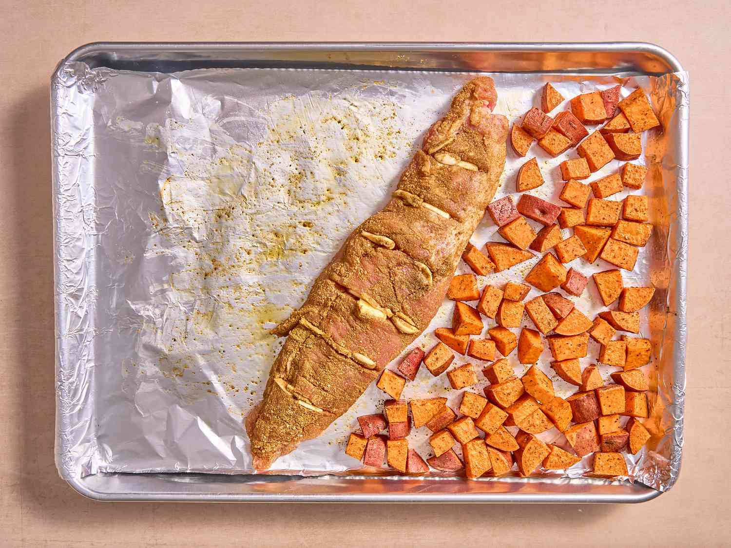 Pork added to sheetpan with sweet potatoes 