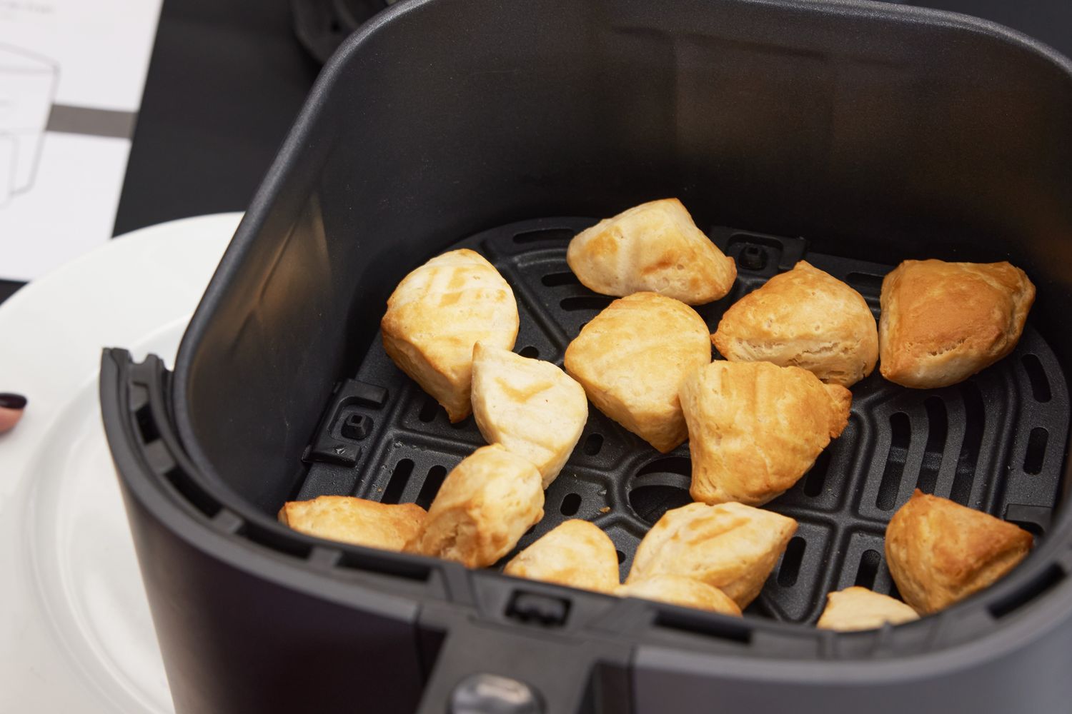 Cooked frozen food ready inside of a Cosari air fryer.