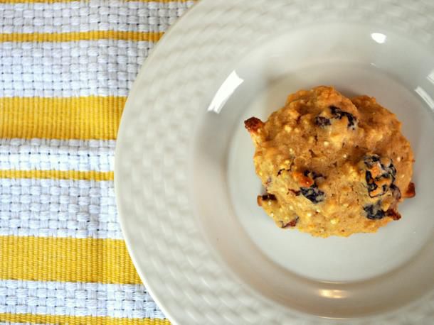 Overhead view of an almond cherry quinoa cookie, served on a white plate.