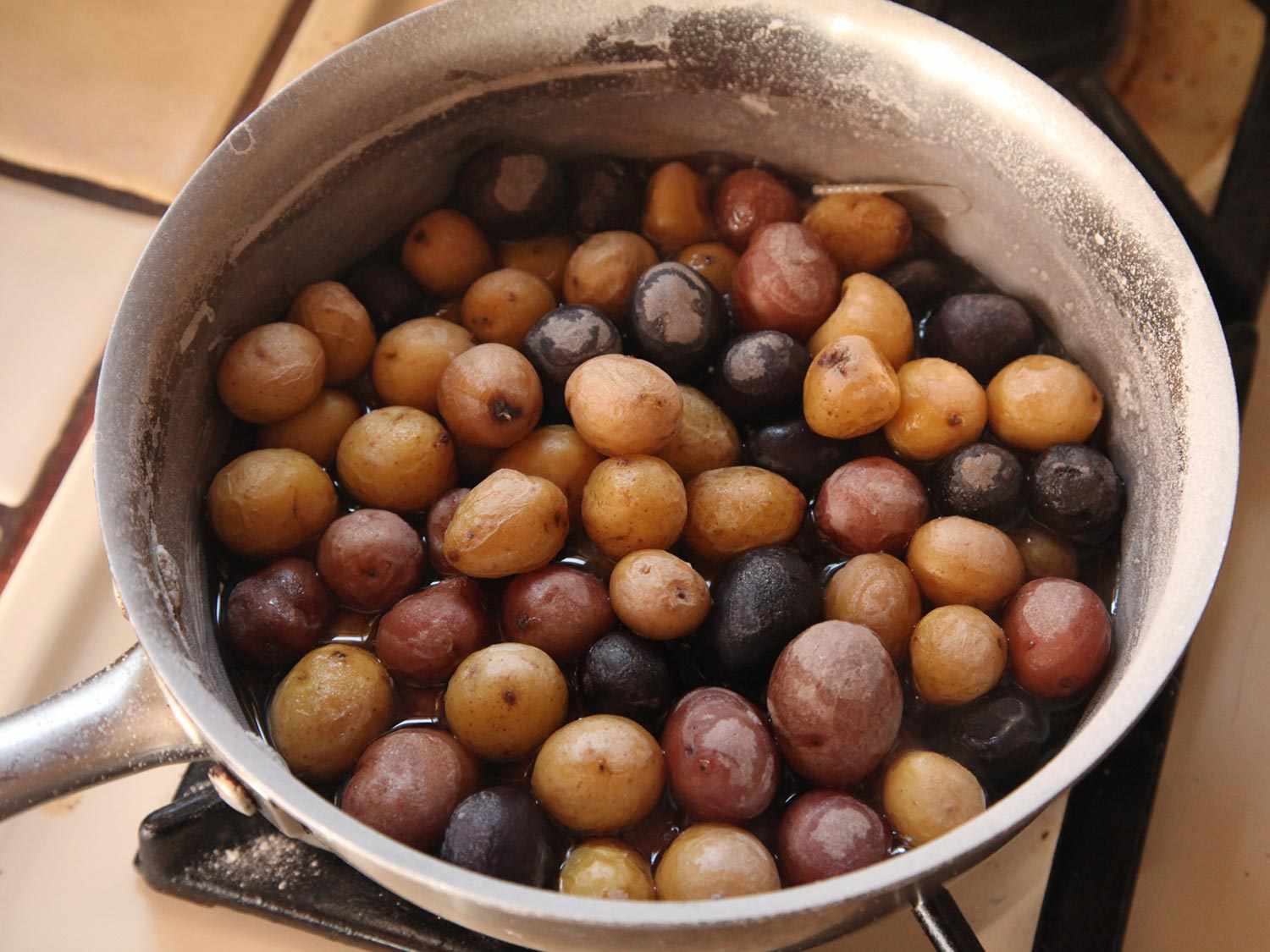 Pot of assorted small potatoes boiled until almost dry