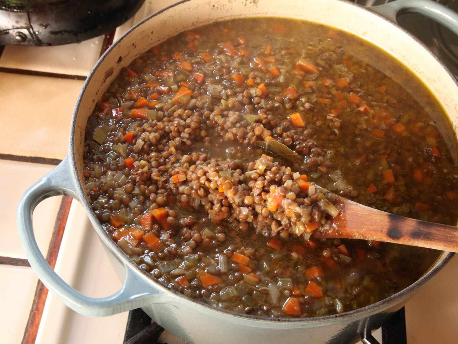 Stirring almost finished lentil soup on the stovetop.