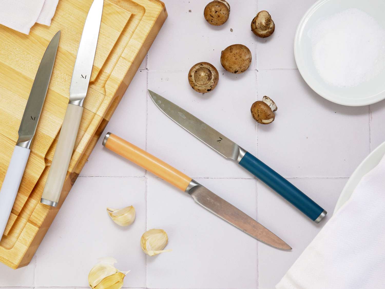 material knives on a white tile surface