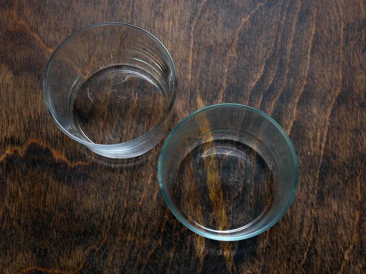 two bormioli short wine glasses on dark wood surface