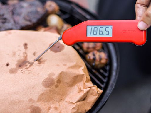 Checking the temperature of ribs on a grill