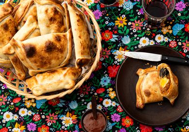Overhead view of Empanadas de Pino on a traditional Chilean fabric