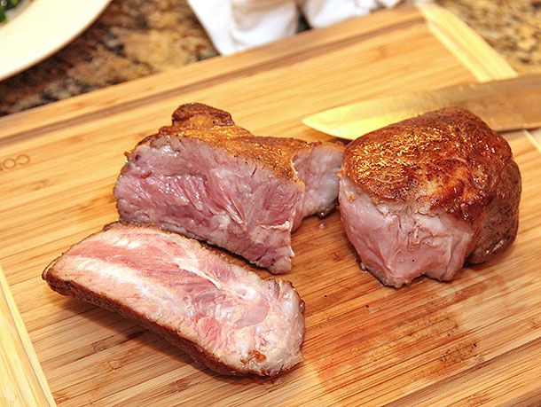 Rosy pink interior of a sous vide double cut pork chop that has been seared. 