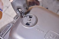 A hand touching the top of the PK Grills Original PK300 Grill & Smoker 