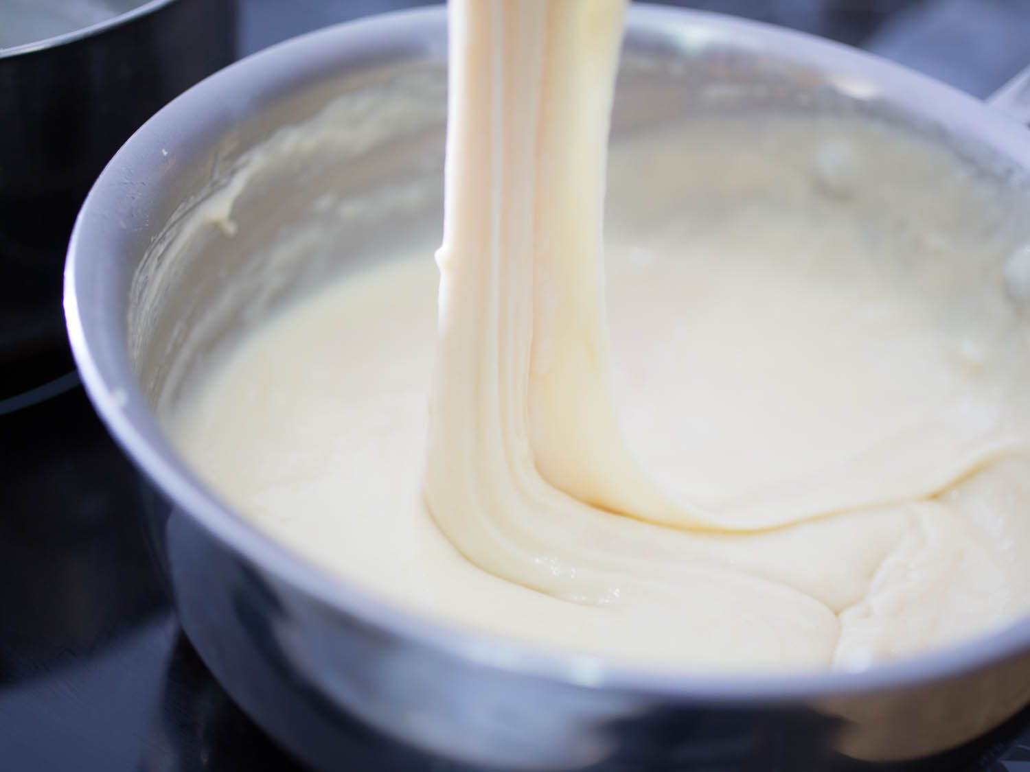 A small saucepan full of a cheese filling candidate.