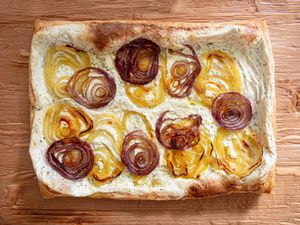 Baked tart with caramelized onion layers on a creamy base