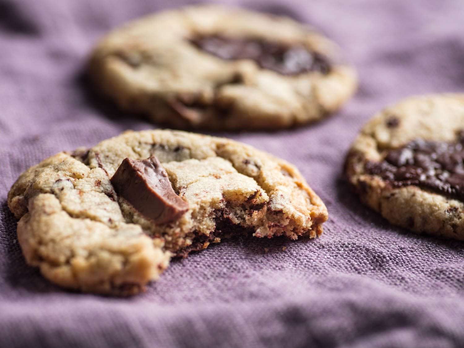 A chocolate chip cookies missing a bite.