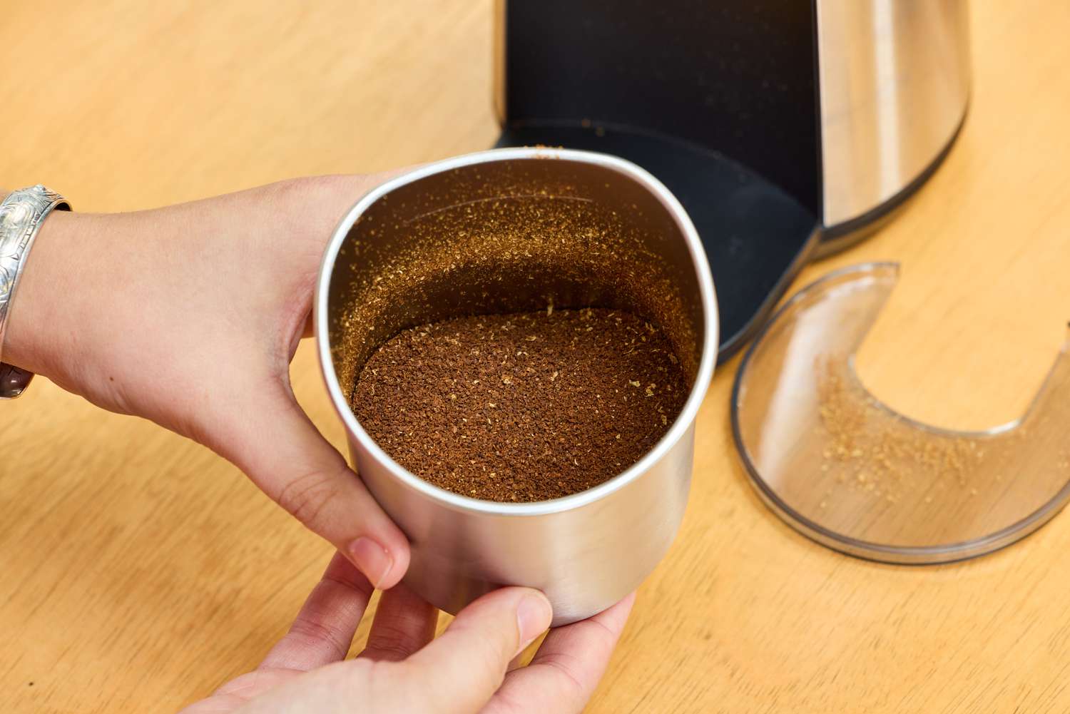 A cup of coffee beans ground in the OXO Brew Conical Burr Coffee Grinder