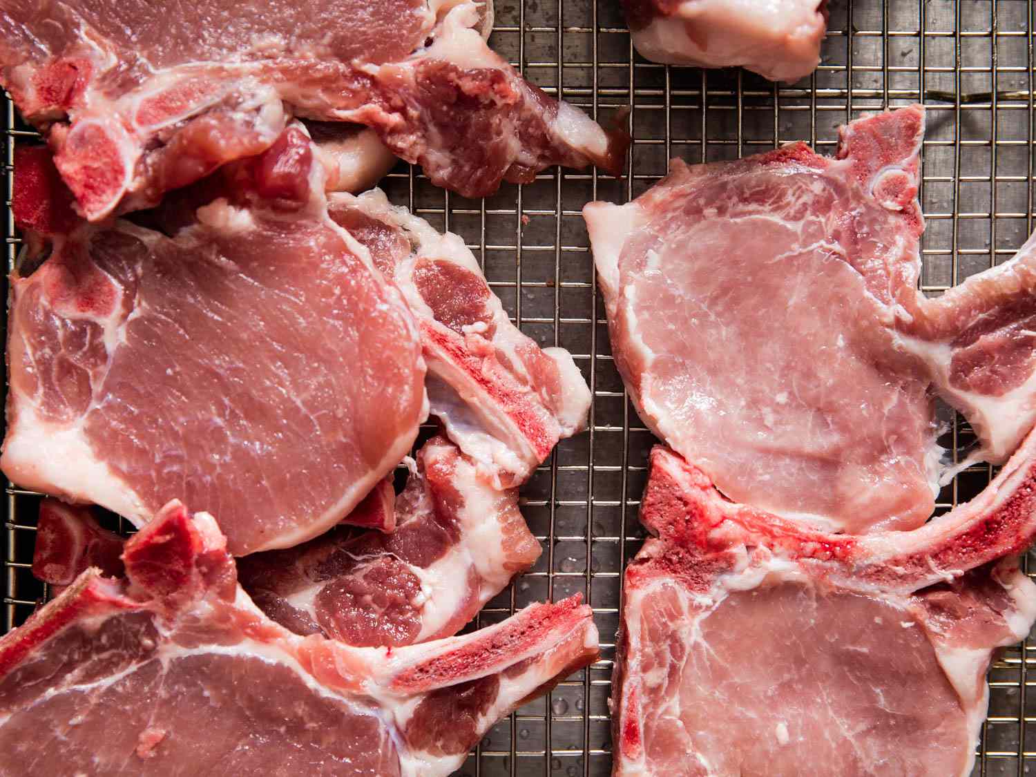 Uncooked bone-in rib chops.