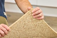 A person lifts the Fulton Standing Mat