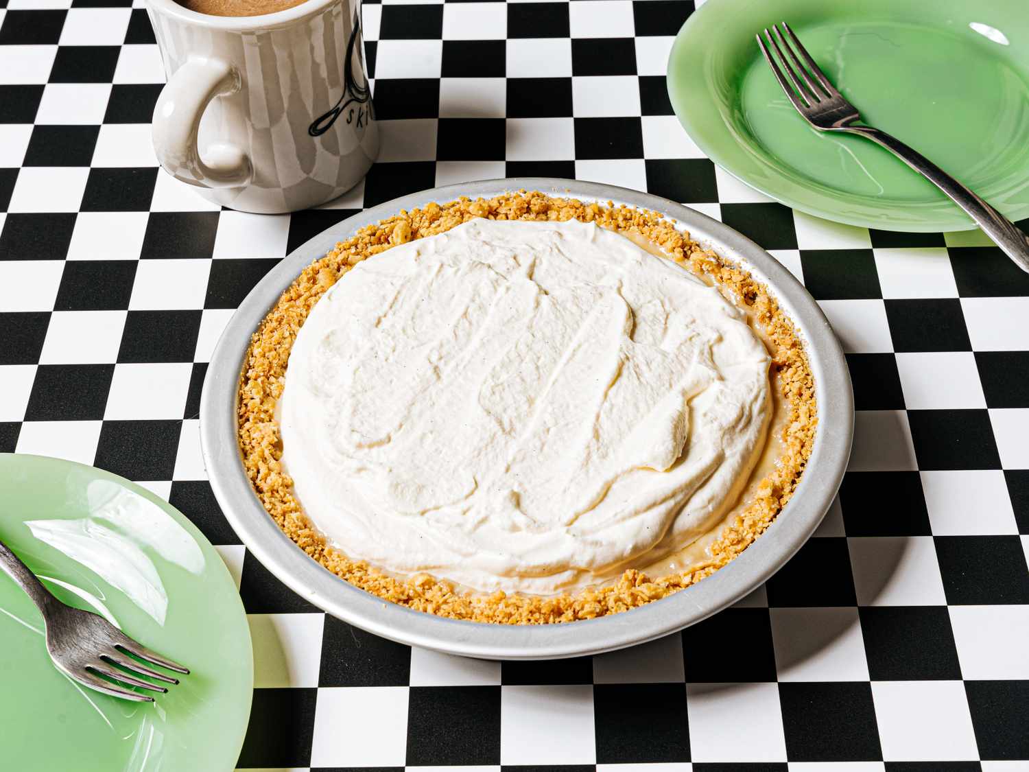 Atlantic Beach pie on a checkered tablecloth served with coffee and green plates