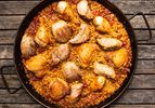 Grilled chicken and pork paella in a paella pan 