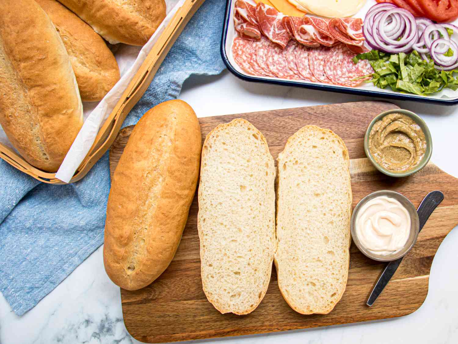 Overhead view of hoagie rolls with sandwich makings