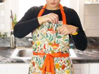 a person putting a sharpie into an apron pocket